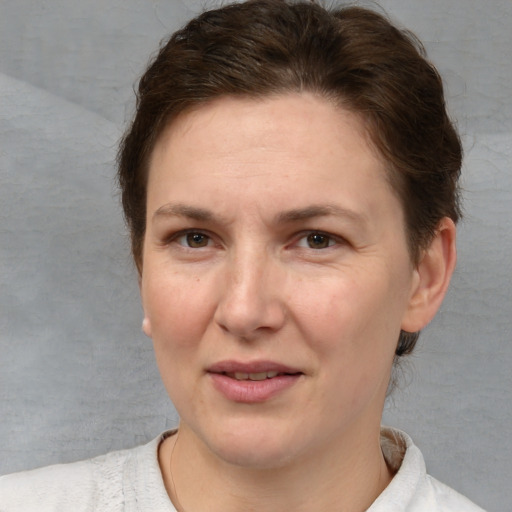 Joyful white adult female with short  brown hair and brown eyes