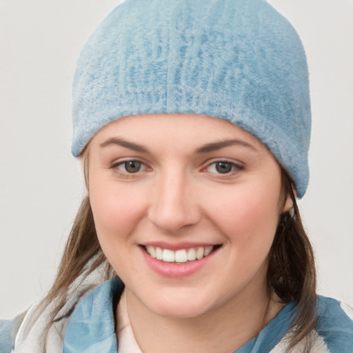 Joyful white young-adult female with medium  brown hair and blue eyes