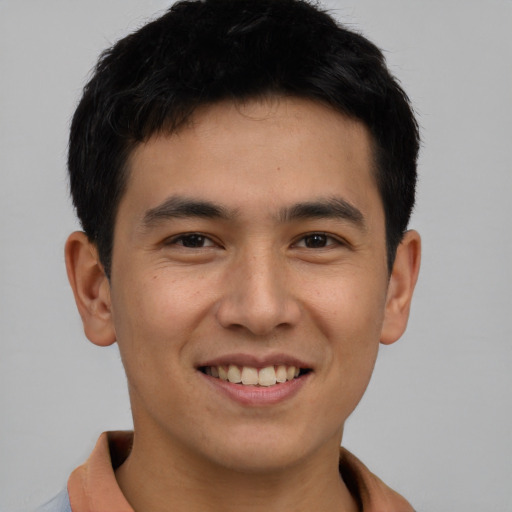 Joyful asian young-adult male with short  brown hair and brown eyes