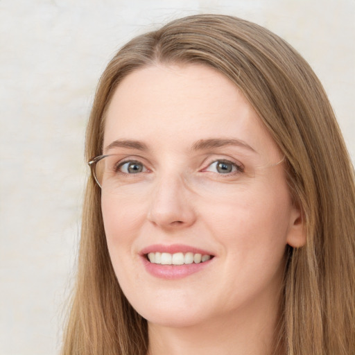 Joyful white young-adult female with long  brown hair and green eyes