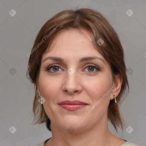 Joyful white adult female with medium  brown hair and grey eyes