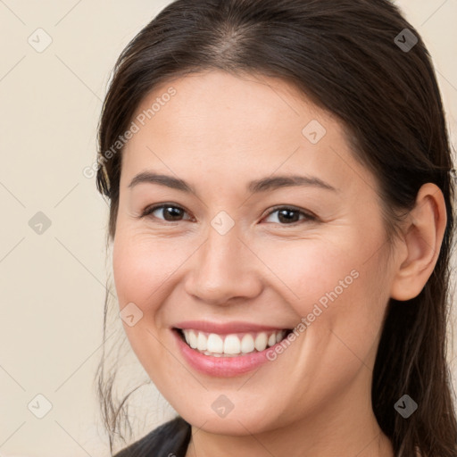 Joyful white young-adult female with long  brown hair and brown eyes