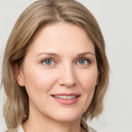 Joyful white young-adult female with medium  brown hair and green eyes