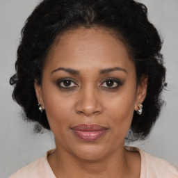 Joyful latino adult female with medium  brown hair and brown eyes