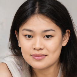 Joyful asian young-adult female with long  brown hair and brown eyes