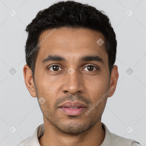 Joyful latino young-adult male with short  black hair and brown eyes