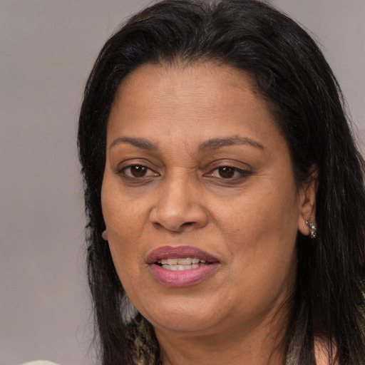 Joyful latino adult female with medium  brown hair and brown eyes