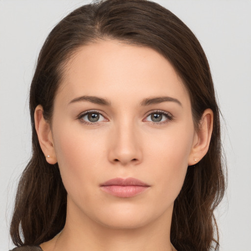 Neutral white young-adult female with long  brown hair and brown eyes