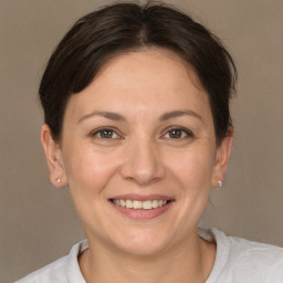 Joyful white adult female with short  brown hair and brown eyes