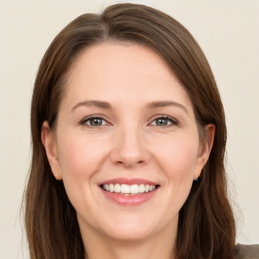 Joyful white young-adult female with long  brown hair and green eyes