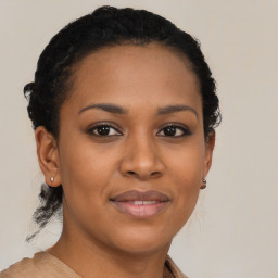 Joyful black young-adult female with short  brown hair and brown eyes