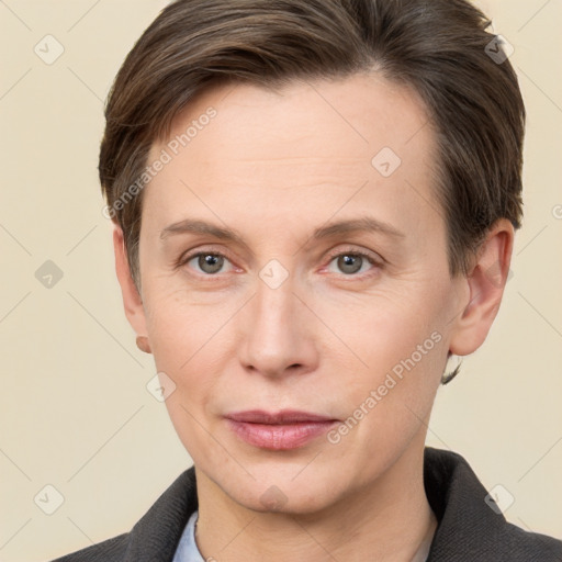 Joyful white adult female with short  brown hair and grey eyes