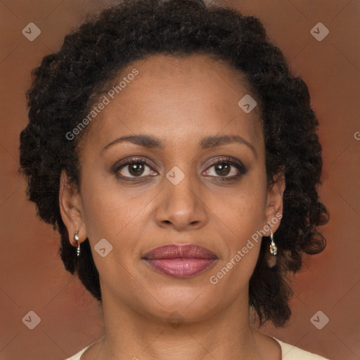 Joyful black adult female with long  brown hair and brown eyes