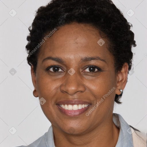 Joyful black adult female with short  brown hair and brown eyes