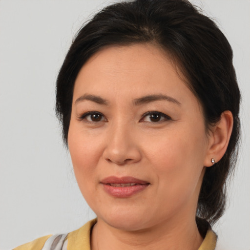 Joyful asian young-adult female with medium  brown hair and brown eyes
