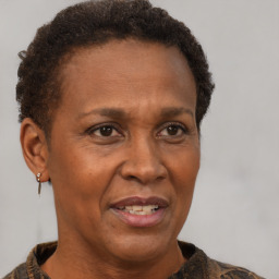 Joyful black adult female with short  brown hair and brown eyes