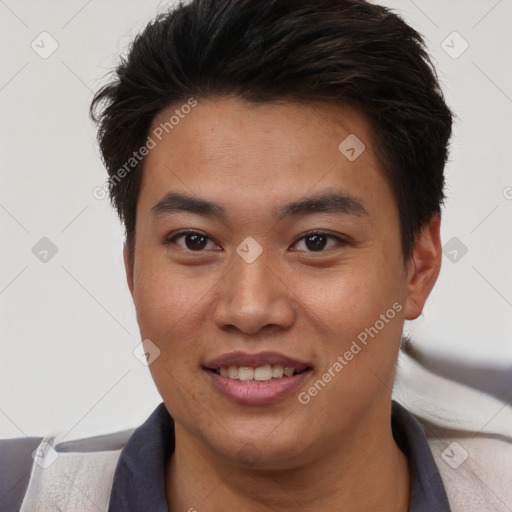 Joyful asian young-adult male with short  brown hair and brown eyes