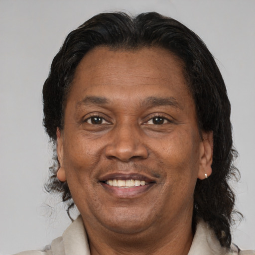 Joyful black adult male with short  brown hair and brown eyes