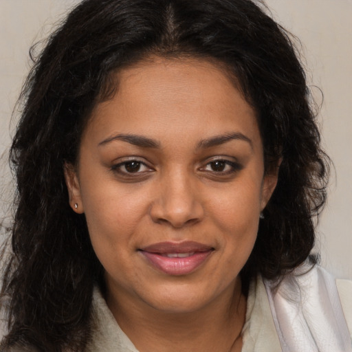 Joyful black young-adult female with medium  brown hair and brown eyes