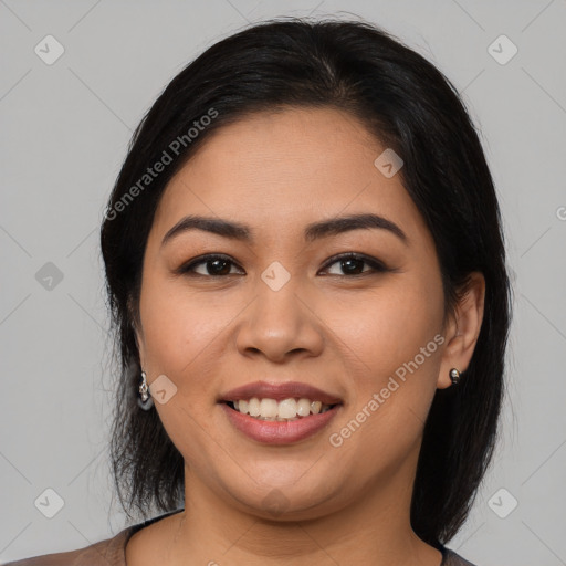 Joyful latino young-adult female with long  black hair and brown eyes