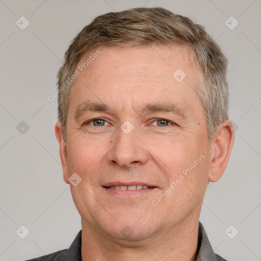 Joyful white adult male with short  brown hair and grey eyes