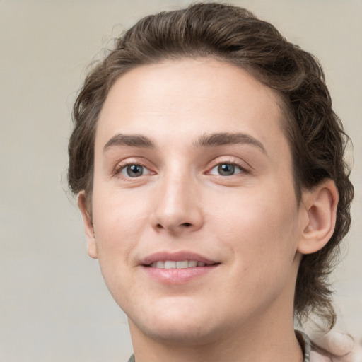 Joyful white young-adult male with medium  brown hair and green eyes