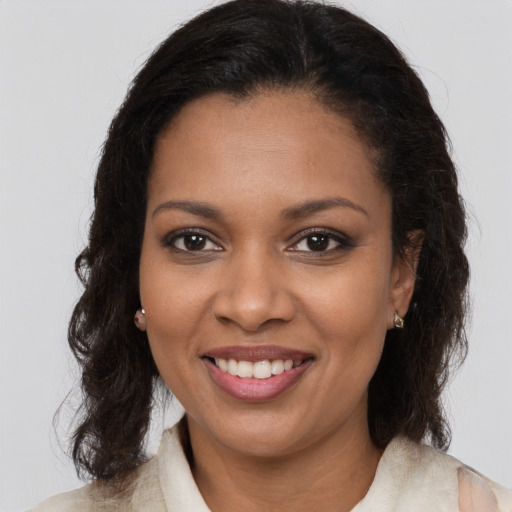 Joyful black young-adult female with medium  brown hair and brown eyes