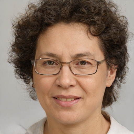 Joyful white adult female with medium  brown hair and green eyes