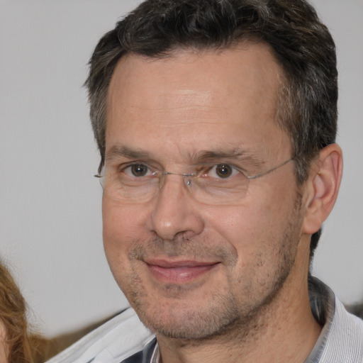 Joyful white adult male with short  brown hair and brown eyes