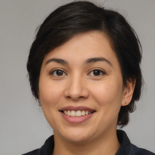 Joyful asian young-adult female with medium  brown hair and brown eyes