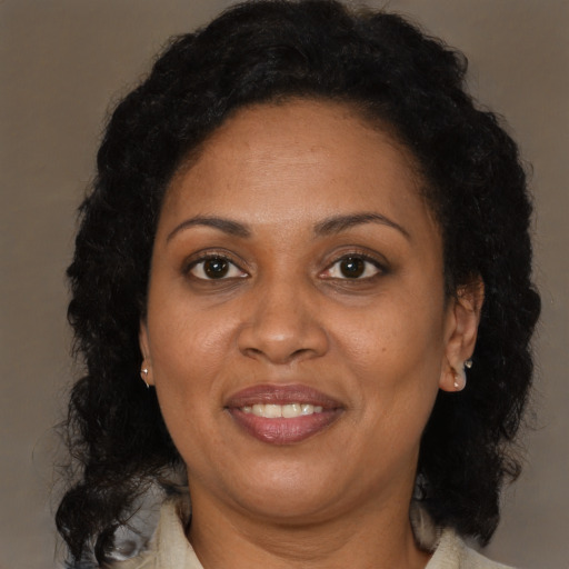 Joyful latino adult female with medium  brown hair and brown eyes