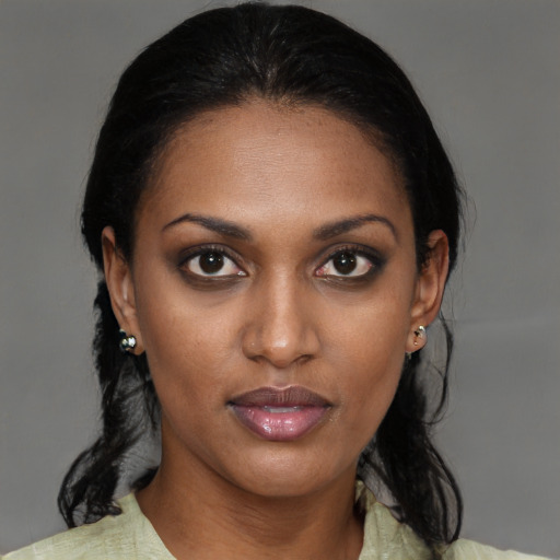 Joyful black young-adult female with medium  brown hair and brown eyes