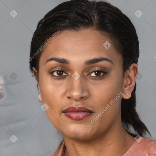 Joyful latino young-adult female with medium  brown hair and brown eyes