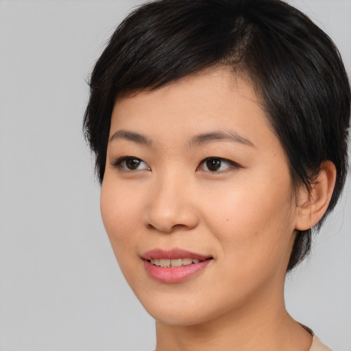 Joyful asian young-adult female with medium  black hair and brown eyes