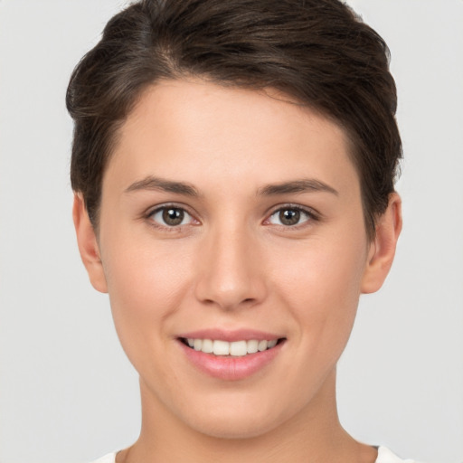 Joyful white young-adult female with short  brown hair and brown eyes