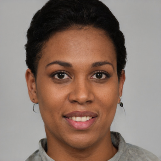 Joyful latino young-adult female with short  black hair and brown eyes