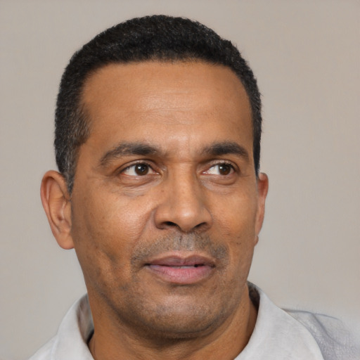 Neutral latino adult male with short  black hair and brown eyes