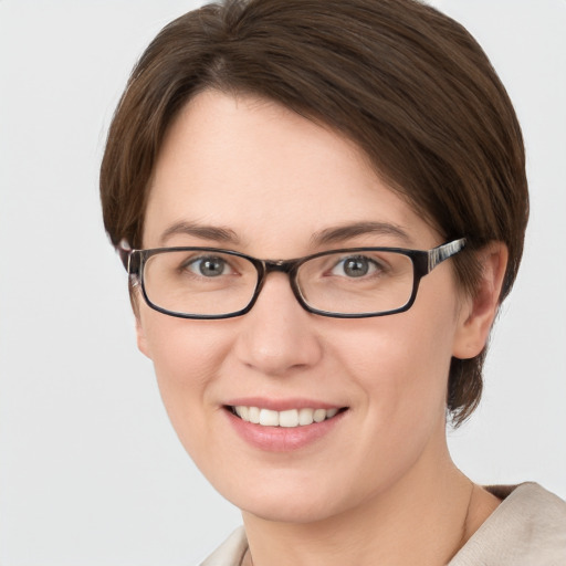 Joyful white young-adult female with short  brown hair and grey eyes