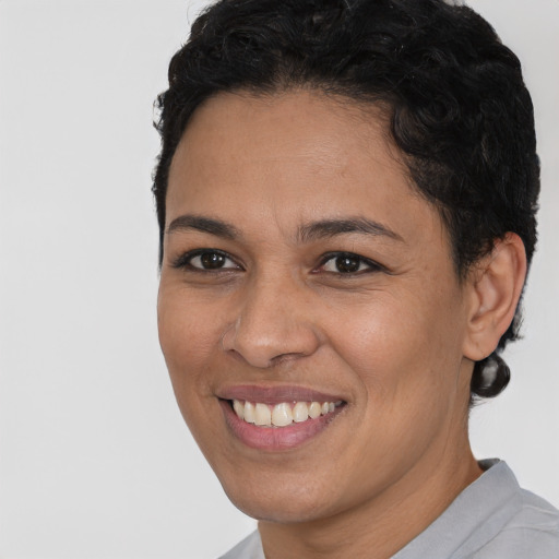 Joyful latino young-adult female with short  brown hair and brown eyes
