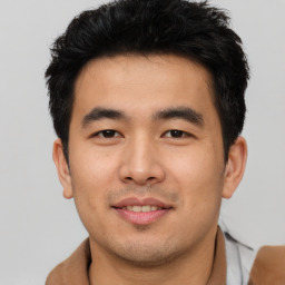 Joyful asian young-adult male with short  brown hair and brown eyes