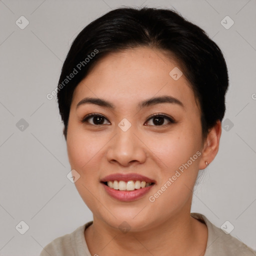 Joyful asian young-adult female with short  brown hair and brown eyes