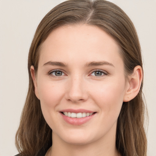 Joyful white young-adult female with long  brown hair and grey eyes