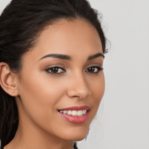 Joyful latino young-adult female with long  brown hair and brown eyes