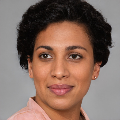 Joyful latino young-adult female with short  brown hair and brown eyes
