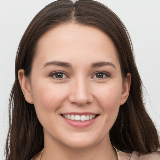 Joyful white young-adult female with long  brown hair and grey eyes