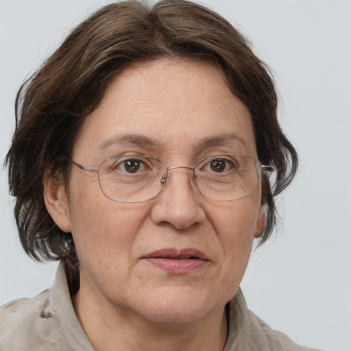 Joyful white middle-aged female with medium  brown hair and grey eyes