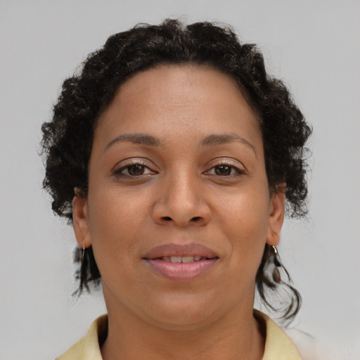 Joyful latino adult female with short  brown hair and brown eyes