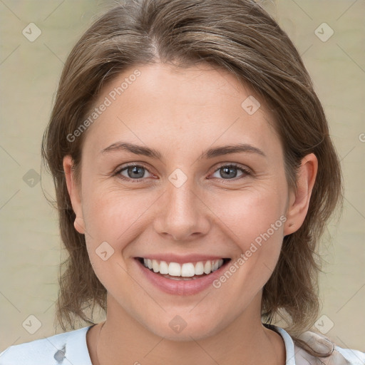 Joyful white young-adult female with medium  brown hair and grey eyes