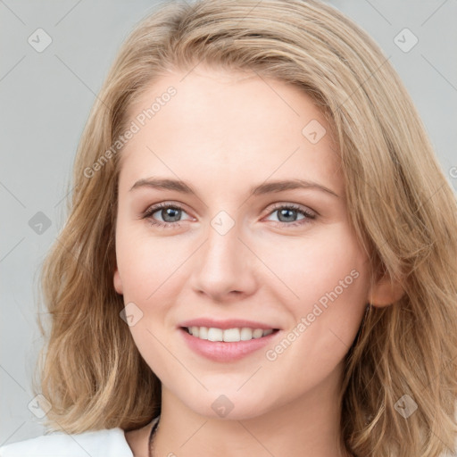 Joyful white young-adult female with long  brown hair and blue eyes