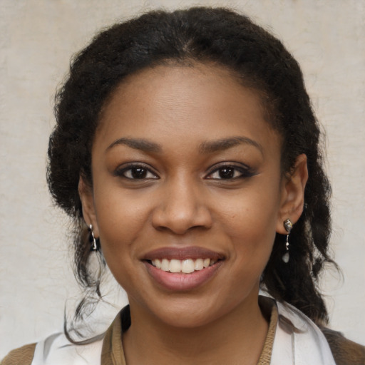 Joyful black young-adult female with medium  brown hair and brown eyes